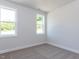 Neutral bedroom with two windows providing ample natural light at 6048 Scalybark Rd, Durham, NC 27712