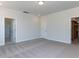 This bright bedroom features plush carpet, a walk-in closet, an en-suite bathroom, and neutral walls at 6048 Scalybark Rd, Durham, NC 27712