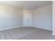 Bedroom with plush carpet, neutral walls, a double-door closet, and decorative trim, offering a bright, neutral design at 6048 Scalybark Rd, Durham, NC 27712