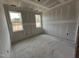 Spacious bedroom with drywall and new flooring, featuring two large windows at 6048 Scalybark Rd, Durham, NC 27712