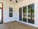 Spacious covered deck featuring sliding glass doors and wood flooring at 6048 Scalybark Rd, Durham, NC 27712
