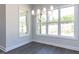 Bright dining area with a contemporary chandelier and large windows at 6048 Scalybark Rd, Durham, NC 27712