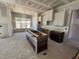 Kitchen with white cabinets, a large island, and a view of the backyard at 6048 Scalybark Rd, Durham, NC 27712