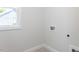 A laundry room with utility connections and a window for natural light at 6048 Scalybark Rd, Durham, NC 27712