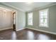 Open-concept room with hardwood floors, lots of natural light, and fresh paint at 6048 Scalybark Rd, Durham, NC 27712