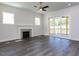 Bright living room features a fireplace, hardwood floors, and access to a covered porch at 6048 Scalybark Rd, Durham, NC 27712