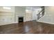 Open living room featuring a fireplace and hardwood floors at 6048 Scalybark Rd, Durham, NC 27712