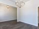 Spacious open-concept room boasts hardwood floors and a modern chandelier at 6048 Scalybark Rd, Durham, NC 27712