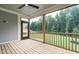 Screened in porch with wood flooring, a ceiling fan, and views of the backyard at 6048 Scalybark Rd, Durham, NC 27712