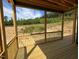 Relaxing screened porch overlooking wooded area at 6048 Scalybark Rd, Durham, NC 27712