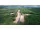 Aerial view showcasing home lots cleared amid lush green forestry near Jordan Lake at 37 Green Turtle Ln, Pittsboro, NC 27312