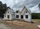 New home construction featuring large windows and archway on a wooded lot at 37 Green Turtle Ln, Pittsboro, NC 27312