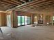 Living room under construction with a fireplace and large sliding glass doors to the backyard at 37 Green Turtle Ln, Pittsboro, NC 27312