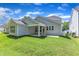 View of the backyard with green grass and part of the home at 9140 Dupree Meadow Dr # 9, Angier, NC 27501