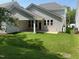 Backyard with covered patio and green lawn at 9140 Dupree Meadow Dr # 9, Angier, NC 27501