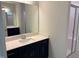 Modern bathroom with a vanity featuring navy cabinets, quartz countertops, and a glass door shower at 9140 Dupree Meadow Dr # 9, Angier, NC 27501