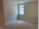 Bright bedroom with neutral walls, carpet and a window offering plenty of natural light at 9140 Dupree Meadow Dr # 9, Angier, NC 27501