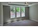 Expansive bedroom with large windows overlooking the trees and a tray ceiling with a fan at 9140 Dupree Meadow Dr # 9, Angier, NC 27501
