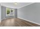 Bright, empty bedroom featuring wood flooring, large windows, and neutral paint at 9140 Dupree Meadow Dr # 9, Angier, NC 27501