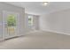 Bright bedroom featuring carpeted flooring, window, and door to deck at 9140 Dupree Meadow Dr # 9, Angier, NC 27501