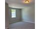 Bright bedroom featuring neutral walls, carpet, and a window with a pleasant view at 9140 Dupree Meadow Dr # 9, Angier, NC 27501
