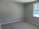 Well-lit bedroom with carpet, neutral walls, and a bright window at 9140 Dupree Meadow Dr # 9, Angier, NC 27501