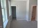 Bedroom featuring closet and bathroom doors, as well as a bright window at 9140 Dupree Meadow Dr # 9, Angier, NC 27501