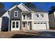 Two-story house with gray siding, white trim, and a two-car garage at 9140 Dupree Meadow Dr # 9, Angier, NC 27501