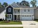 Charming two-story home featuring a balcony, gray siding, black accents, and a well-maintained lawn at 9140 Dupree Meadow Dr # 9, Angier, NC 27501