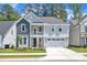 Charming two-story home with a welcoming front porch and attached two car garage at 9140 Dupree Meadow Dr # 9, Angier, NC 27501
