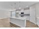 Open kitchen with white cabinets, stainless appliances, and center island offers a stylish and functional space at 9140 Dupree Meadow Dr # 9, Angier, NC 27501