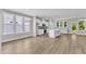Open-concept kitchen with island, stainless appliances, large windows and light wood floors create an inviting space at 9140 Dupree Meadow Dr # 9, Angier, NC 27501