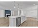 Open-concept kitchen with island features stainless steel appliances and a seamless transition to the living space at 9140 Dupree Meadow Dr # 9, Angier, NC 27501