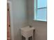 A convenient laundry sink is located under a window at 9140 Dupree Meadow Dr # 9, Angier, NC 27501