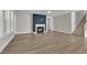 Open living room boasts luxury vinyl plank flooring, a modern fireplace and staircase access at 9140 Dupree Meadow Dr # 9, Angier, NC 27501