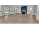 Bright living room features a modern fireplace, large windows, and luxury vinyl plank flooring at 9140 Dupree Meadow Dr # 9, Angier, NC 27501