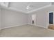 Expansive main bedroom with neutral carpet, modern ceiling fan, and tray ceiling at 9140 Dupree Meadow Dr # 9, Angier, NC 27501