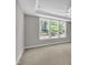 Bright primary bedroom with neutral carpet, modern ceiling fan, and large windows with backyard views at 9140 Dupree Meadow Dr # 9, Angier, NC 27501