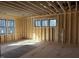 Unfinished bedroom with large windows and hardwood floors at 1317 Old Lystra Rd, Chapel Hill, NC 27517