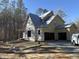 Under construction home with yellow siding and two car garage at 1317 Old Lystra Rd, Chapel Hill, NC 27517