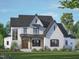 Two-story modern farmhouse with white brick exterior, dark roof, and wood accents at 1317 Old Lystra Rd, Chapel Hill, NC 27517