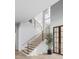 Modern staircase with metal railing and wood steps at 5312 Alpine Dr, Raleigh, NC 27609