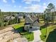 Aerial view of a house with three-car garage, a manicured lawn, and mature trees at 820 Willow Tower Ct # 153, Rolesville, NC 27571