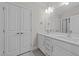 Bathroom with dual sinks, white cabinetry, and modern fixtures at 820 Willow Tower Ct # 153, Rolesville, NC 27571