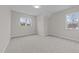 A bright, empty bedroom with neutral walls and two windows offering natural light at 820 Willow Tower Ct # 153, Rolesville, NC 27571