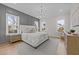 Light-filled primary bedroom with panel molding, a chandelier and large windows at 820 Willow Tower Ct # 153, Rolesville, NC 27571