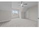 Cozy bedroom features neutral carpet, gray walls, window, door, and a ceiling fan at 820 Willow Tower Ct # 153, Rolesville, NC 27571