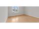 Empty room with hardwood floors and a large window offering a view of the exterior at 820 Willow Tower Ct # 153, Rolesville, NC 27571