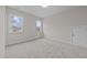 Bright bedroom features neutral carpet, gray walls, two windows, and an access door at 820 Willow Tower Ct # 153, Rolesville, NC 27571