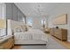 Bright bedroom with a comfortable bed, chandelier and neutral decor to make your own at 820 Willow Tower Ct # 153, Rolesville, NC 27571